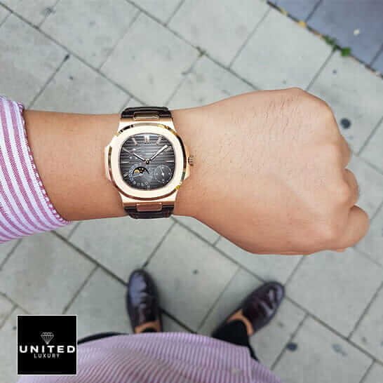 Patek Philippe Nautilus 5712R-001 Patek Philippe Rose Gold Case Black Dial Leather Bracelet Replica on the man wrist